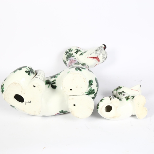 773 - A large Italian dog with painted floral decoration, 43cm, and matching small dog