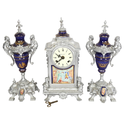 795 - A silvered brass and ceramic cased clock garniture, with figure and cherub decoration, lacking glass... 