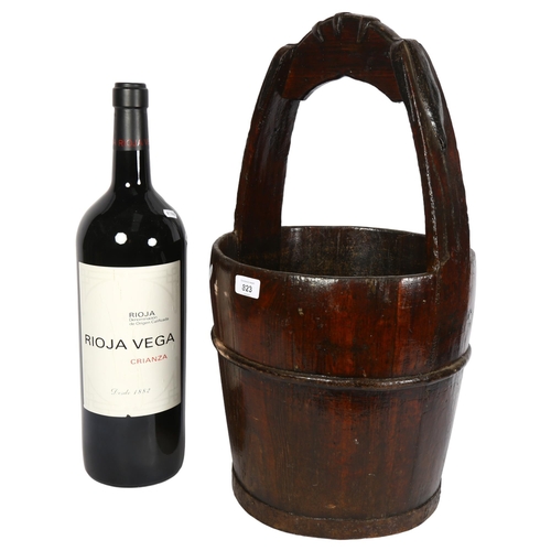 823 - A Chinese wooden well bucket, height 62cm, and a shop display Rioja Vega bottle