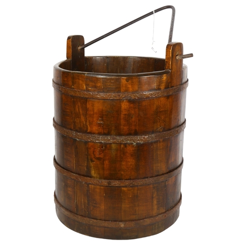 824 - A metal-bound wooden bucket with swing handle, height 35cm