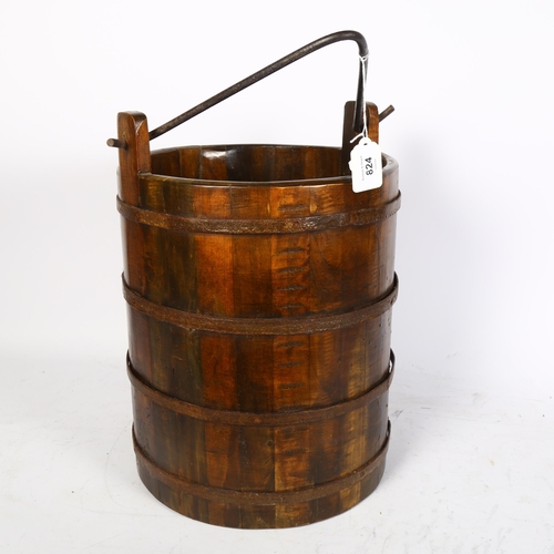 824 - A metal-bound wooden bucket with swing handle, height 35cm