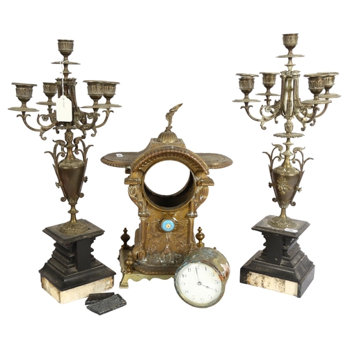 831 - Art Nouveau embossed brass mantel clock with eagle pediment, height 35cm, and a pair of 5-branch bra... 