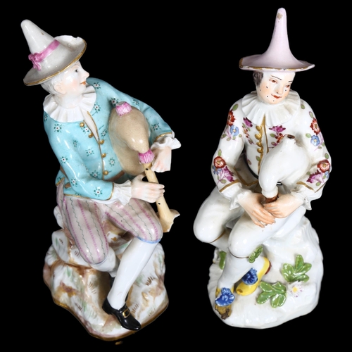 885 - A pair of Continental porcelain musician figures seated on rocks, with blue cross swords mark, heigh... 