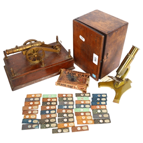 903 - A small brass microscope (no maker), in fitted case, a desk-top cannon, and a collection of Victoria... 