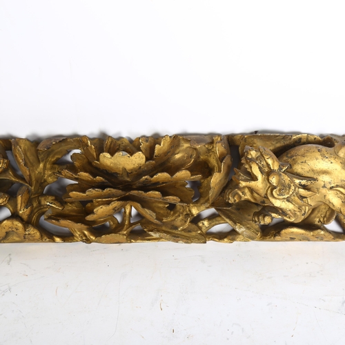 921 - A 19th century carved gilt gesso panel of Chinese Foo Dogs and central flower, length 62cm