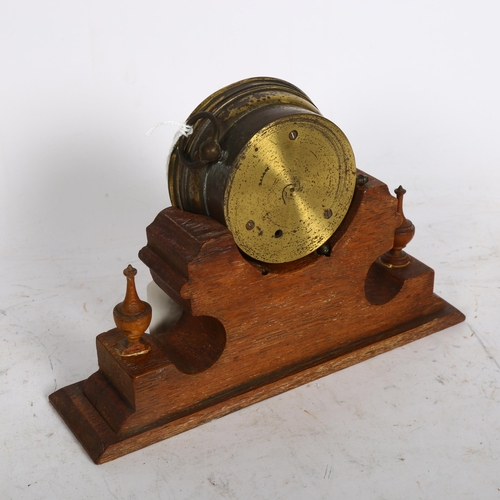 924 - A brass-cased aneroid barometer, maker's mark SJL & Co, on fitted Gothic oak base, width 22cm