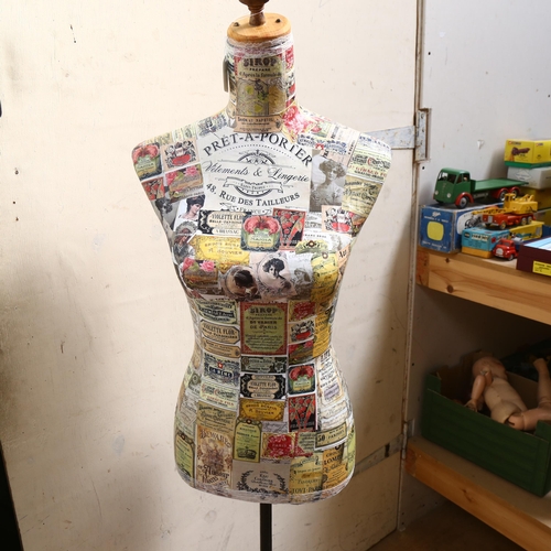 929 - Clive Fredriksson, a decoupage decorated half-size mannequin of the female form, on pine tripod stan... 