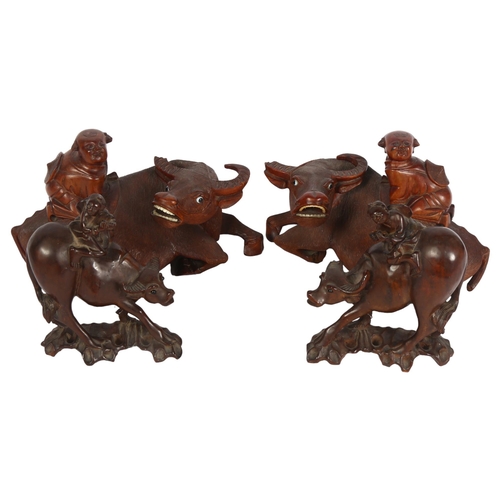 1003 - A pair of Chinese water buffalo, surmounted by figures, height 15cm, and a pair of smaller Chinese c... 