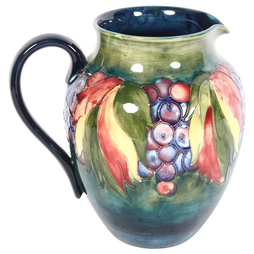 1010 - Antique Moorcroft jug with tube-lined fruit decoration, signed (A/F), height 19cm