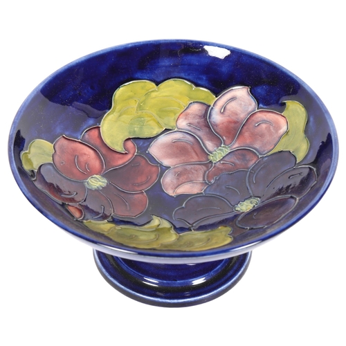 1014 - A blue ground Moorcroft pedestal comport, with tube-lined floral decoration, signed, diameter 18cm