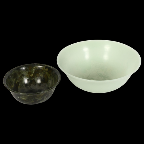 1022 - A jade bowl and a spinach jade bowl, on foot, 12.5cm across