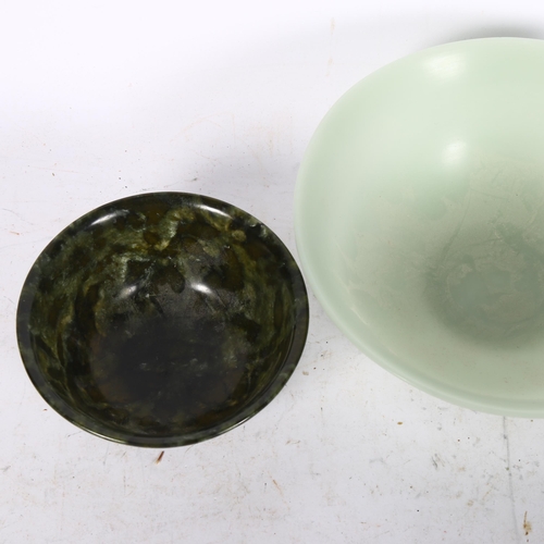 1022 - A jade bowl and a spinach jade bowl, on foot, 12.5cm across