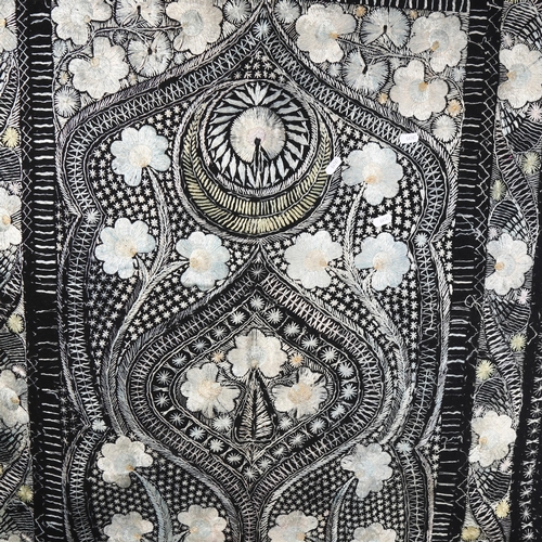 1034 - A black wool throw with embroidered floral decoration, 226cm x 110cm