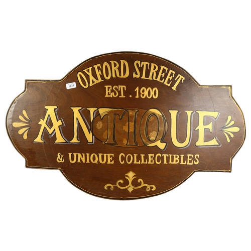 1038 - A painted wood sign advertising Antiques, Oxford Street, length 95cm