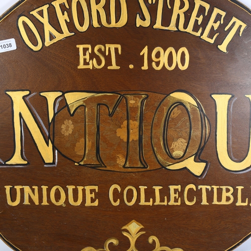 1038 - A painted wood sign advertising Antiques, Oxford Street, length 95cm