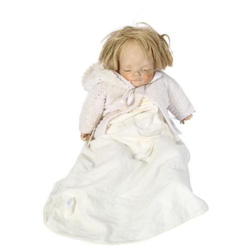 1041 - A Joyce Wolf sculpture porcelain-head sleeping baby doll, length 49cm