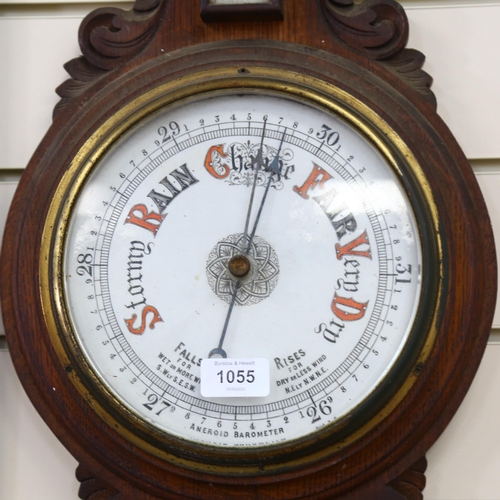 1055 - A Victorian carved oak-framed aneroid barometer, length 90cm