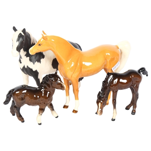 975 - A Royal Doulton palomino, Shetland foal and another, and a piebald pony