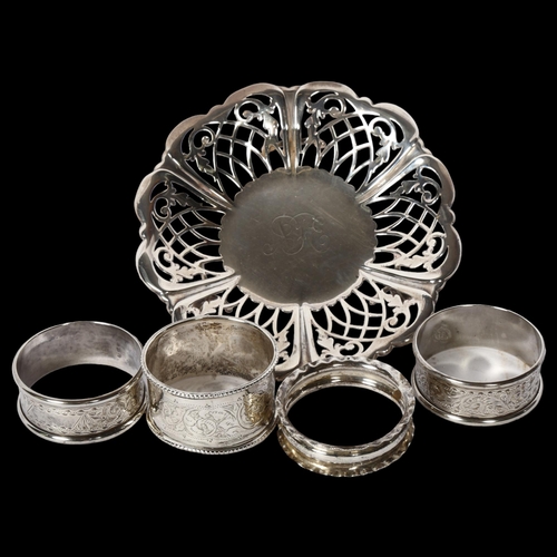 1233 - A small pierced silver dish with monogram centre, and 4 silver napkin rings, 3.2oz