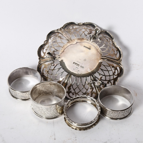 1233 - A small pierced silver dish with monogram centre, and 4 silver napkin rings, 3.2oz