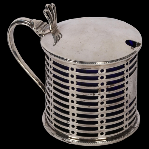 1239 - A George V silver drum-shape mustard pot, with pierced decoration and blue glass liner, London 1912,... 