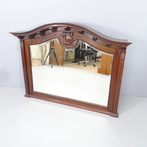 2216 - An antique mahogany framed arch-top over mantle mirror, with applied carved decoration. 133x104x16cm