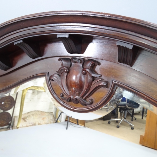 2216 - An antique mahogany framed arch-top over mantle mirror, with applied carved decoration. 133x104x16cm