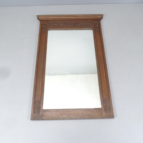 2220 - A French oak wall mirror, with applied carved decoration. 88x130cm