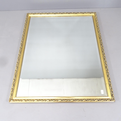 2221 - A modern gilt-framed wall mirror. 132x103cm