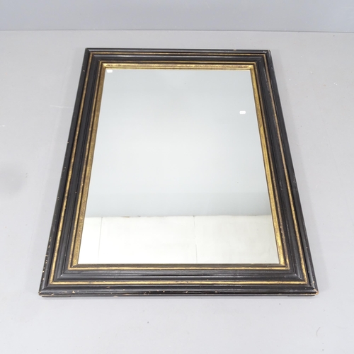 2222 - An ebonised and gilt-painted cushion framed wall mirror. 93x118cm