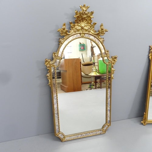 2224 - An antique continental giltwood cushion framed wall mirror, with applied foliate decoration. 64x120c... 