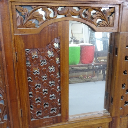 2228 - A Balinese hardwood shuttered mirror. Overall 80x90cm, mirrored panel 45x49cm.