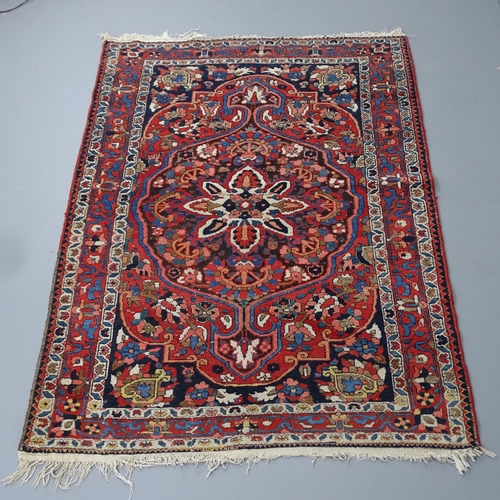 2295 - A red-ground Sarouk rug. 200x136cm