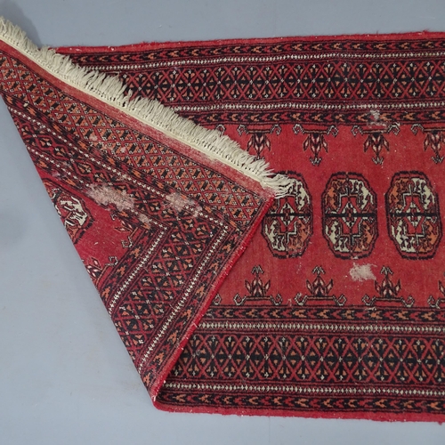 2296 - A red-ground Bokhara runner. 280x80cm