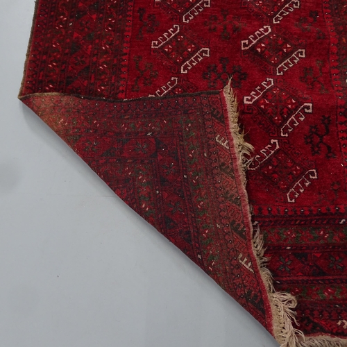 2298 - A red-ground Turkaman rug. 204x130cm.