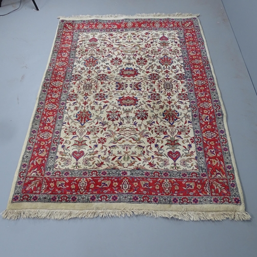 2300 - A red and cream ground Persian rug. 220x144cm.