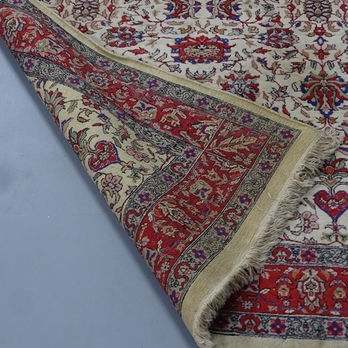 2300 - A red and cream ground Persian rug. 220x144cm.