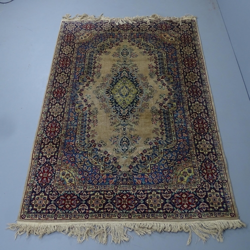 2303 - A cream-ground Kerman rug. 220x140cm