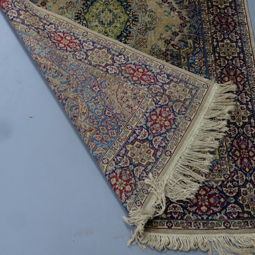 2303 - A cream-ground Kerman rug. 220x140cm