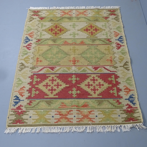 2304 - A cream-ground Kilim rug. 182x126cm.