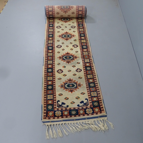 2314 - A cream-ground Persian design runner. 528x76cm