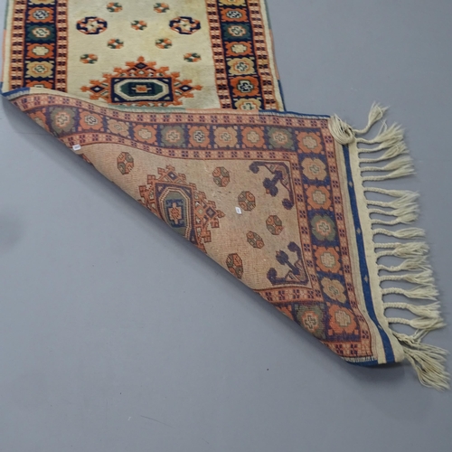 2314 - A cream-ground Persian design runner. 528x76cm