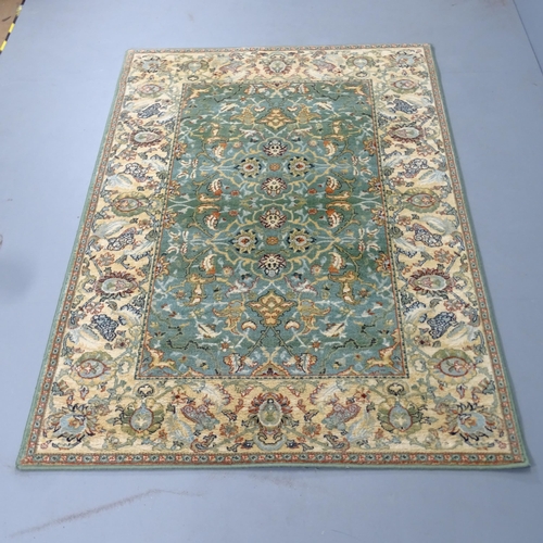 2334 - A cream-ground Serapi design carpet. 202x142cm.