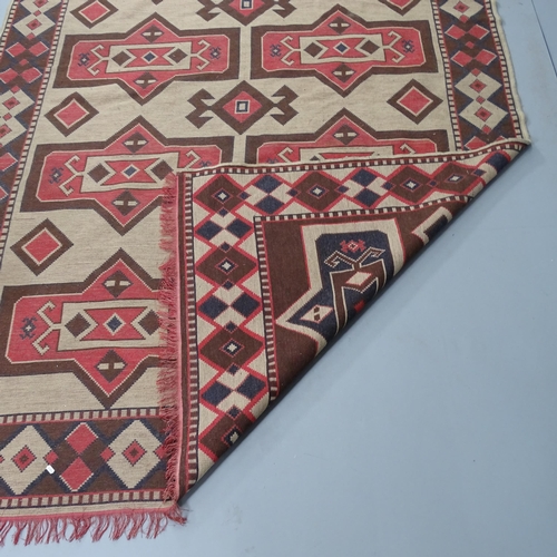 2336 - A cream-ground Kilim carpet. 295x205cm.