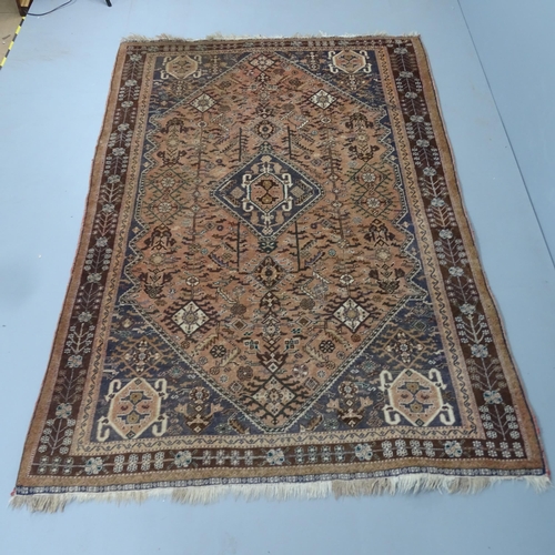 2337 - A red-ground Qashqai carpet. 240x156cm.