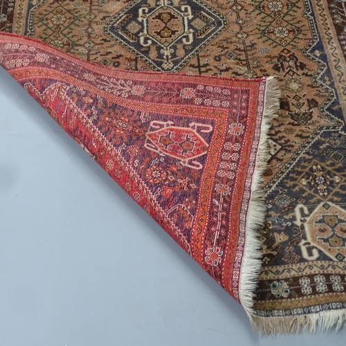 2337 - A red-ground Qashqai carpet. 240x156cm.