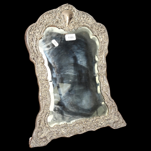 1105 - A late Victorian large silver-fronted dressing table mirror, with allover engraved and embossed deco... 