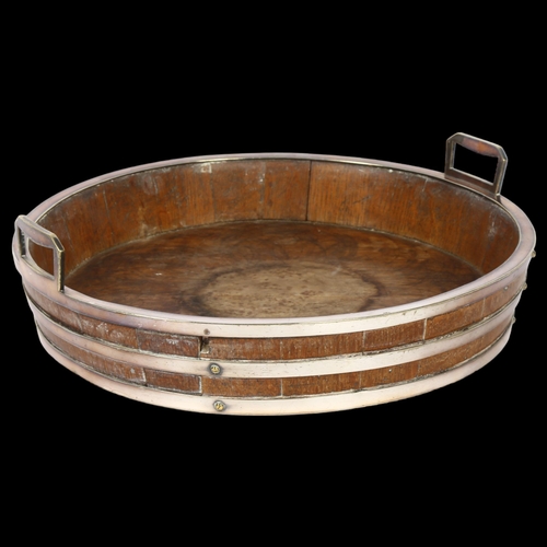 1106 - An early 20th century oak and silver plated bound 2-handled serving tray, diameter 30cm