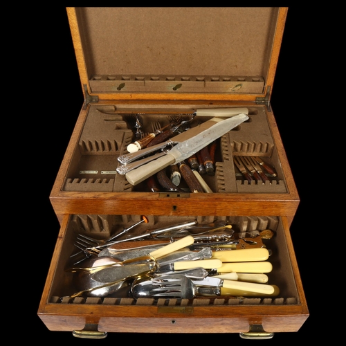 1109 - A 1920s oak drawer-fitted canteen with a quantity of mixed ivorine-handled and horn-handled cutlery ... 