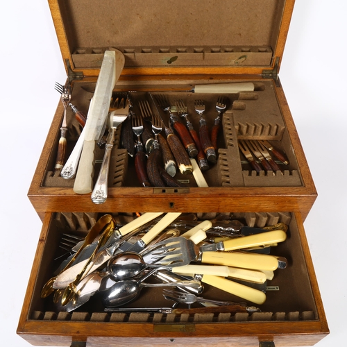 1109 - A 1920s oak drawer-fitted canteen with a quantity of mixed ivorine-handled and horn-handled cutlery ... 